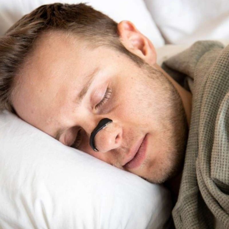 Man sleeping with a magnetic nasal strip