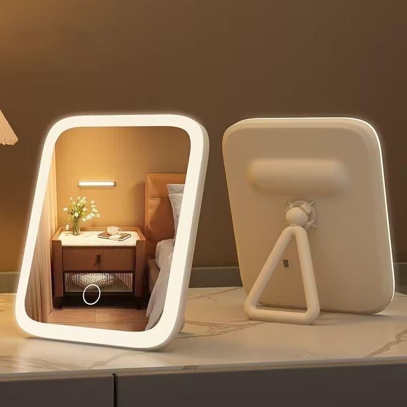 Lighted vanity mirror with a wall-mounted fixture on a countertop.