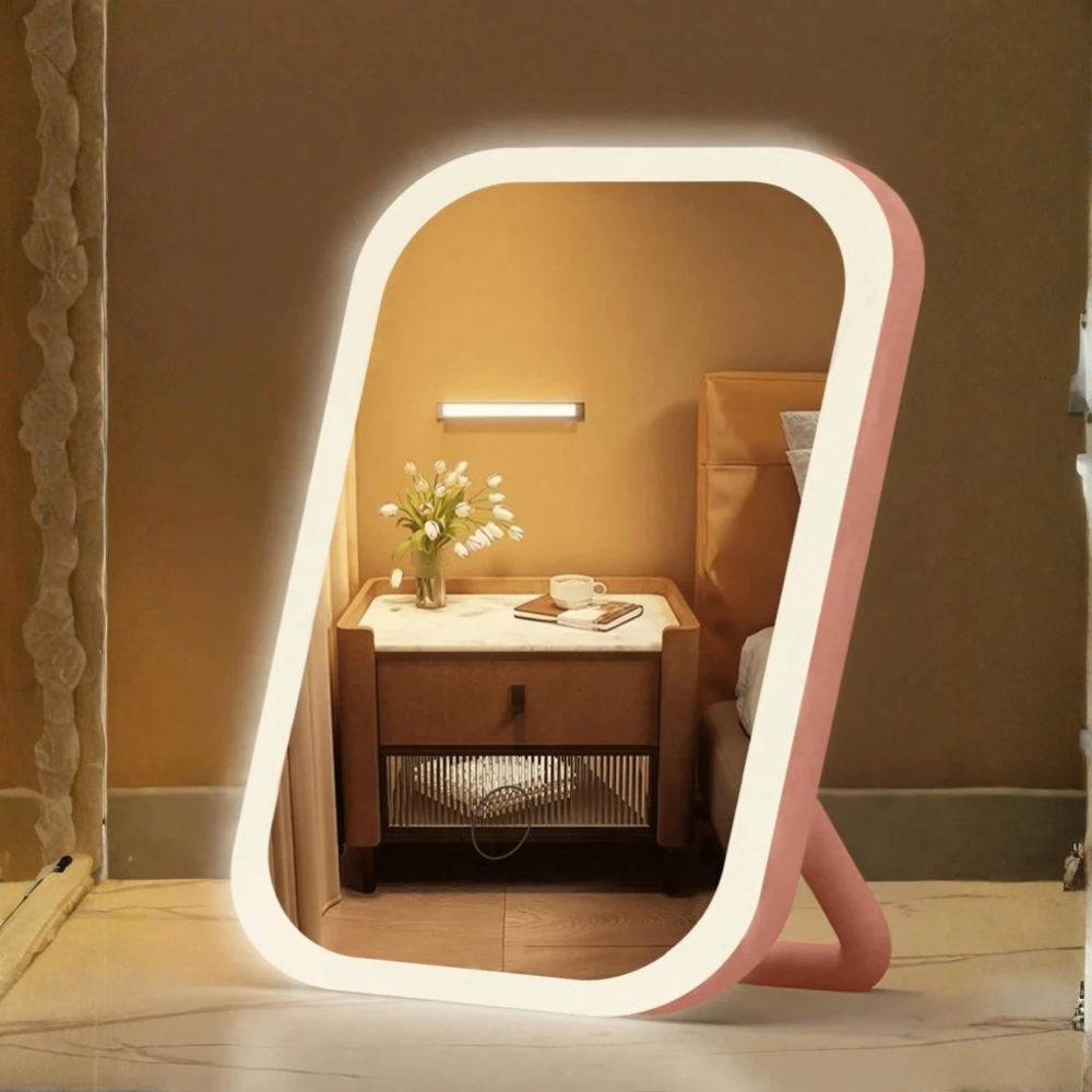 Pink LED-framed mirror on a wooden floor with a blurred background