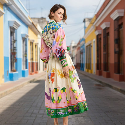 Woman in a colorful dress standing on a street with colorful buildings.