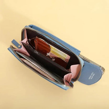 Blue wallet with sunglasses and pink items on a beige background