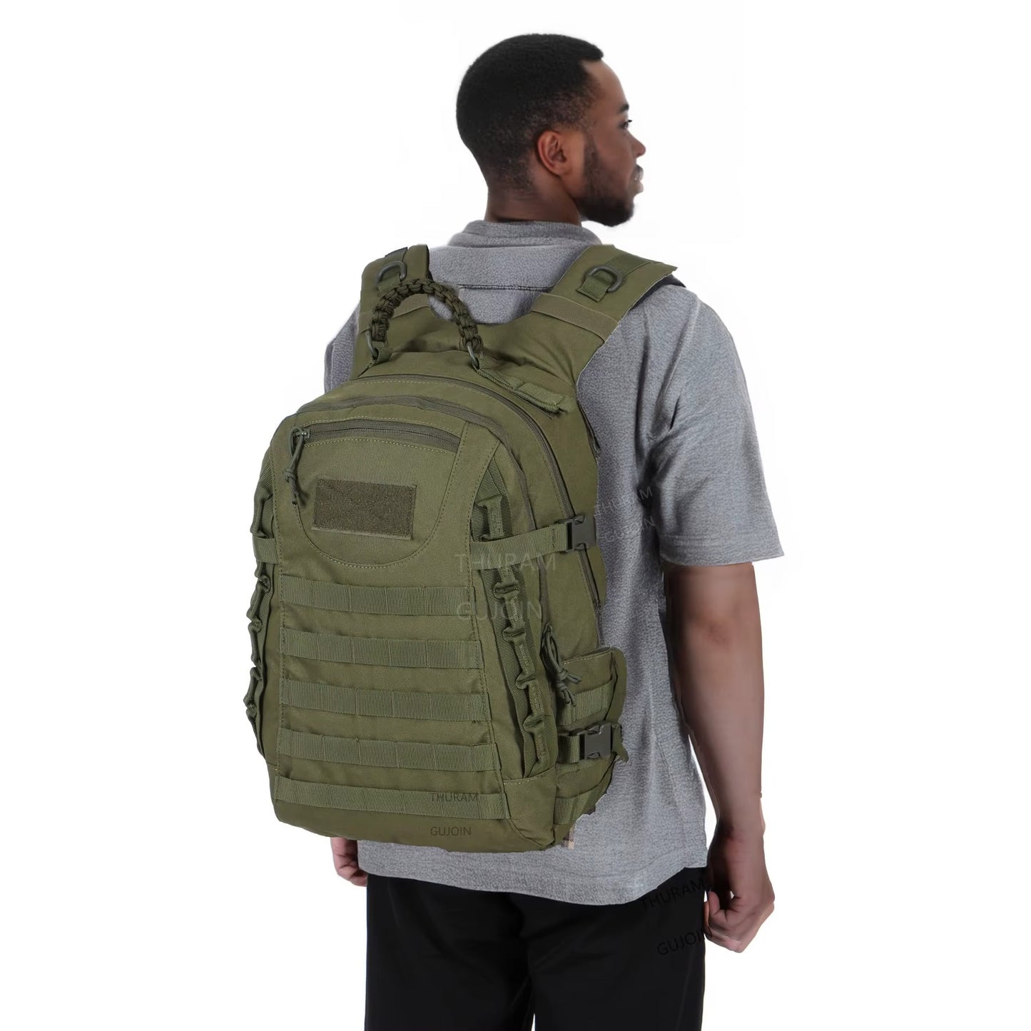Person wearing a green tactical backpack on a white background